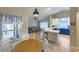Bright kitchen with white and blue cabinets, a bar top counter and stainless steel appliances in an open floor plan at 5152 Panther Dr, Spring Hill, FL 34607