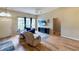 Inviting living room with wood flooring, a large window providing natural light, and comfortable seating for relaxation at 5152 Panther Dr, Spring Hill, FL 34607