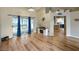 Spacious living room with vaulted ceilings, sliding glass doors to the patio, and an open view of the kitchen at 5152 Panther Dr, Spring Hill, FL 34607