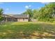View of the backyard from the lanai showing solar panels and a fenced in yard at 5216 Hope Ln, Spring Hill, FL 34606