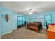 Spacious bedroom with comfortable carpet, ceiling fan, and abundant windows, offering a tranquil retreat at 5216 Hope Ln, Spring Hill, FL 34606