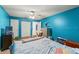 Inviting bedroom with bright blue walls, ceiling fan, and ample natural light, creating a relaxing atmosphere at 5216 Hope Ln, Spring Hill, FL 34606
