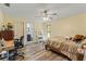 Cozy bedroom with desk area, ensuite bathroom, and hardwood-style floors, blending comfort and practicality at 5216 Hope Ln, Spring Hill, FL 34606