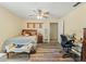 Comfortable bedroom featuring a ceiling fan, hardwood-style floors, and natural light, ideal for relaxation at 5216 Hope Ln, Spring Hill, FL 34606
