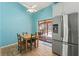 Breakfast nook with a wood table, stainless steel refrigerator, and a view of the outdoor patio at 5216 Hope Ln, Spring Hill, FL 34606