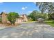 Exterior view of house with covered boat storage and an expansive driveway at 5216 Hope Ln, Spring Hill, FL 34606