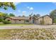 Beautiful single-story home with stone accents, mature landscaping, and an American flag at 5216 Hope Ln, Spring Hill, FL 34606