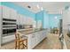 Kitchen with white cabinets, granite countertops, stainless appliances and an island with seating at 5216 Hope Ln, Spring Hill, FL 34606