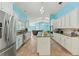 Spacious kitchen with an island, stainless steel appliances, granite countertops, and white cabinets at 5216 Hope Ln, Spring Hill, FL 34606