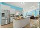 Bright kitchen with island, stainless appliances and granite countertops, open to the dining and living areas at 5216 Hope Ln, Spring Hill, FL 34606