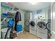 Organized laundry room with washer, dryer, shelving, and storage cabinets at 5216 Hope Ln, Spring Hill, FL 34606