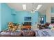 Spacious living room boasts sky lights, ceiling fan, comfortable leather seating, and neutral tile floors at 5216 Hope Ln, Spring Hill, FL 34606
