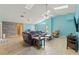 Large open living room featuring a modern leather sofa, wood look flooring, and plenty of natural light at 5216 Hope Ln, Spring Hill, FL 34606