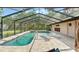 Large screened in pool with a paver surround and chaise lounges at 5216 Hope Ln, Spring Hill, FL 34606