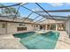 A screened in pool with an outdoor dining area at 5216 Hope Ln, Spring Hill, FL 34606