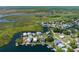 Waterfront homes with access to canals, surrounded by green landscapes and a serene coastal community from above at 5234 Foxhall Ct, Weeki Wachee, FL 34607