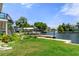 Lush backyard featuring well-maintained lawn, landscaping, and waterfront access, perfect for outdoor enjoyment at 5234 Foxhall Ct, Weeki Wachee, FL 34607
