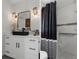 Modern bathroom featuring a stylish vanity, decorative mirror, and elegant shower with white tile at 5234 Foxhall Ct, Weeki Wachee, FL 34607