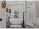 Bright primary bathroom featuring soaking tub, shower, and modern decor at 5234 Foxhall Ct, Weeki Wachee, FL 34607