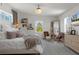 Comfortable bedroom with crystal ceiling fan, wood grain floors, comfortable seating and bright natural light at 5234 Foxhall Ct, Weeki Wachee, FL 34607