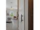Partial view of the bedroom with wood grain flooring and bright natural light at 5234 Foxhall Ct, Weeki Wachee, FL 34607