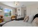 Bedroom featuring bright natural light, wood grain floors and comfortable seating area with views to the outside at 5234 Foxhall Ct, Weeki Wachee, FL 34607