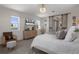 Comfortable bedroom with crystal ceiling fan and decorative sliding barn door to the bathroom at 5234 Foxhall Ct, Weeki Wachee, FL 34607