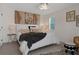 Comfortable bedroom featuring a large decorative wall hanging, a crystal ceiling fan and wood grain flooring at 5234 Foxhall Ct, Weeki Wachee, FL 34607