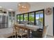 The dining room features a decorative light fixture with a waterfront view and an adjacent modern kitchen at 5234 Foxhall Ct, Weeki Wachee, FL 34607