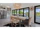 Elegant dining area with a rustic wooden table and chairs, complemented by a modern chandelier at 5234 Foxhall Ct, Weeki Wachee, FL 34607