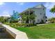 Charming waterfront two-story home featuring tropical landscaping, a lush lawn, and a welcoming porch at 5234 Foxhall Ct, Weeki Wachee, FL 34607