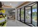 Garage with large folding glass doors leading to outdoor area at 5234 Foxhall Ct, Weeki Wachee, FL 34607