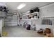 Clean garage featuring ample storage racks, room for a car, and a bright overhead light at 5234 Foxhall Ct, Weeki Wachee, FL 34607