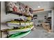 Organized garage featuring storage racks and kayaks, offering plenty of room for equipment and gear at 5234 Foxhall Ct, Weeki Wachee, FL 34607