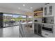Open kitchen with modern bar, ample storage, and stunning views for seamless entertaining at 5234 Foxhall Ct, Weeki Wachee, FL 34607