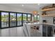 An open-concept kitchen featuring a breakfast bar, stunning waterfront views and seamless indoor/outdoor living at 5234 Foxhall Ct, Weeki Wachee, FL 34607