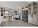 Modern kitchen featuring white cabinetry, stainless steel appliances and a breakfast bar area at 5234 Foxhall Ct, Weeki Wachee, FL 34607