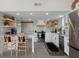 Bright, modern kitchen with stainless steel appliances, white cabinets, and stylish tile backsplash at 5234 Foxhall Ct, Weeki Wachee, FL 34607