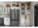 Charming kitchen features stainless steel refrigerator, custom white cabinets and decorative door with storage at 5234 Foxhall Ct, Weeki Wachee, FL 34607