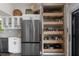 Open custom storage inside a decorative door highlights the kitchen's functional design with modern elegance at 5234 Foxhall Ct, Weeki Wachee, FL 34607