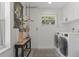 Modern laundry room with front loading washer/dryer, decorative accents and ample natural light at 5234 Foxhall Ct, Weeki Wachee, FL 34607