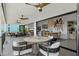 Outdoor patio features ceiling fans with seating and an open view to the indoor dining room and kitchen at 5234 Foxhall Ct, Weeki Wachee, FL 34607