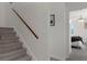 View of the gray wood staircase leading to the bedroom at 5234 Foxhall Ct, Weeki Wachee, FL 34607