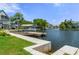 A picturesque waterfront with a wooden dock, offering easy access to the water for boating and recreation at 5234 Foxhall Ct, Weeki Wachee, FL 34607