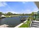 Picturesque waterfront view from the property, featuring a boat lift and serene canal at 5234 Foxhall Ct, Weeki Wachee, FL 34607