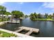 Picturesque waterfront view featuring lush landscaping, docks, and a serene canal setting at 5234 Foxhall Ct, Weeki Wachee, FL 34607