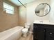 Bathroom featuring a tiled shower, black vanity, and modern fixtures at 5713 Townhouse Dr # 5713, New Port Richey, FL 34652