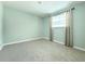 Neutral bedroom with carpet flooring, a window, and soft light gray walls at 5713 Townhouse Dr # 5713, New Port Richey, FL 34652