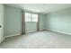 Neutral bedroom with carpet flooring, a window, and soft light gray walls at 5713 Townhouse Dr # 5713, New Port Richey, FL 34652