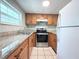 A well-lit kitchen featuring wooden cabinets, granite countertops, and stainless steel appliances at 5713 Townhouse Dr # 5713, New Port Richey, FL 34652